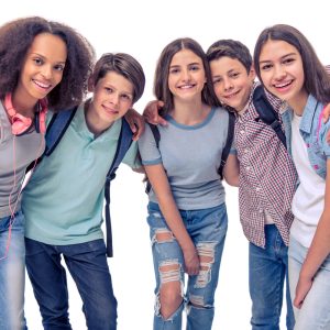 Group of teenage boys and girls with school backpacks is looking at camera and smiling isolated on white
